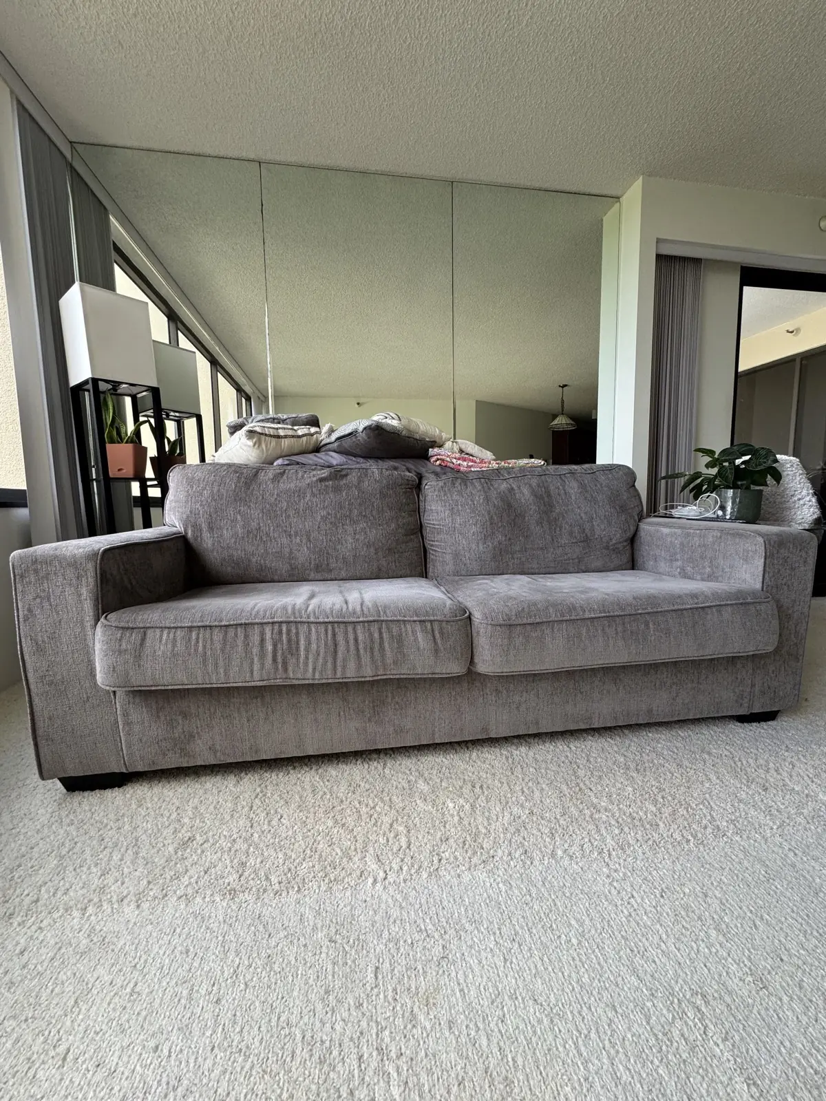 Gray sofa, valley-view condo — before cleaning